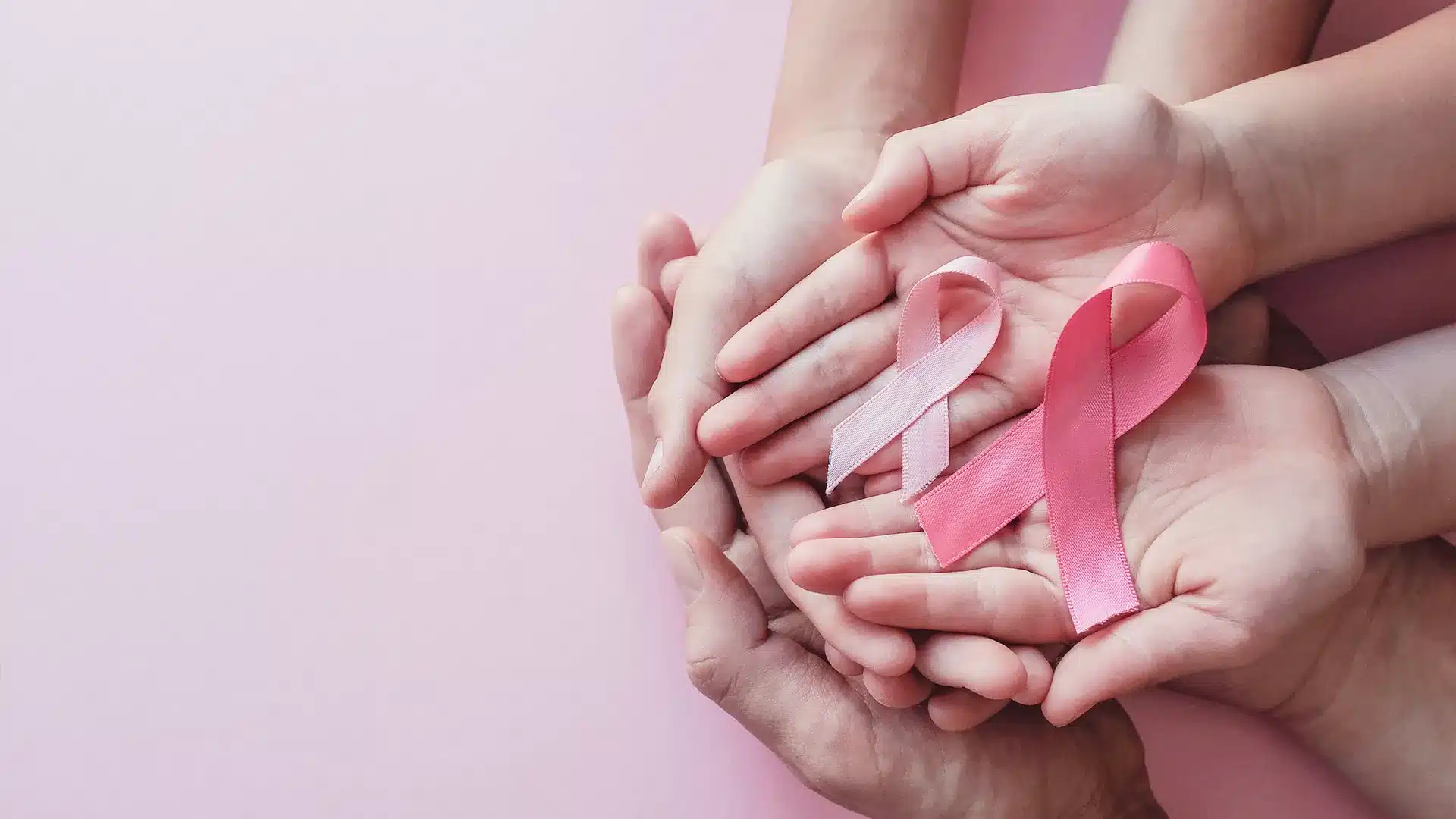 Breast Cancer Ribbon Held in Hands